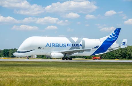 An Airbus Beluga XL stands on a runway.