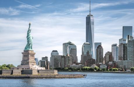 A view of part of Manhattan, with the Statue of Liberty in the foreground and One World Trade Center in the background.
