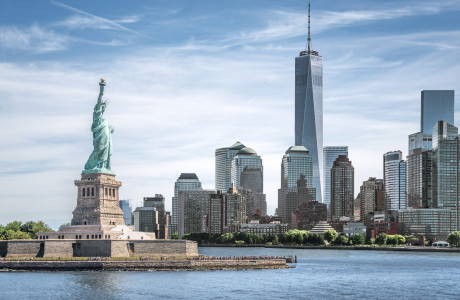 A view of part of Manhattan, with the Statue of Liberty in the foreground and One World Trade Center in the background.