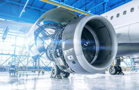 An airplane turbine being assembled in a hangar.