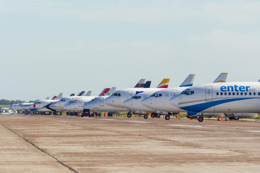 Airplanes from different airlines side by side on a tarmac.
