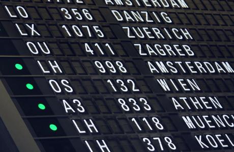 Departure board displaying different international flights.