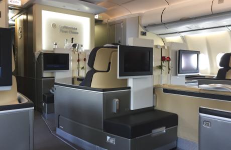 Lufthansa First Class with several seats and monitors.