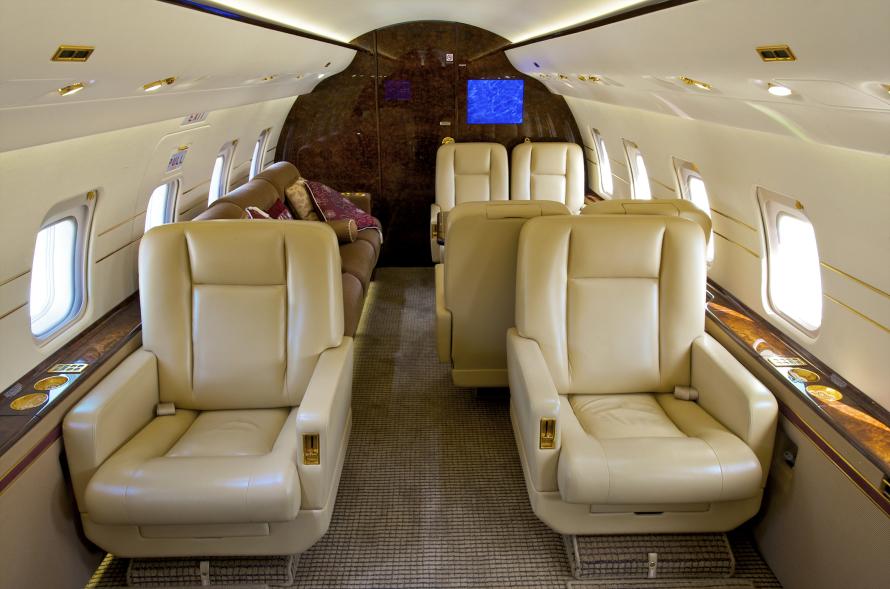 A spacious private jet with comfortable seats from the inside.